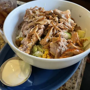 El Lago bowl with pork carnitas, sour cream on the side.