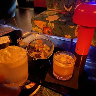 a coffee maker and drinks on a table