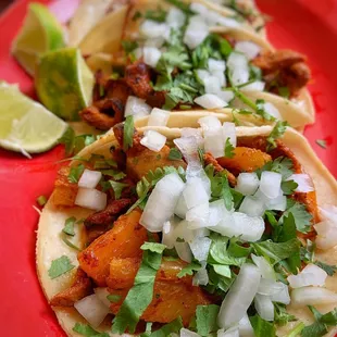 three tacos on a red plate