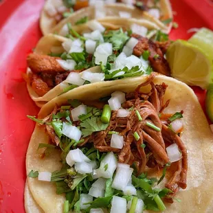 three tacos on a red plate