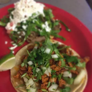 Al pastor taco and carnitas tostada