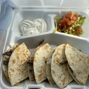 tortilla and salad in a styrofoam container