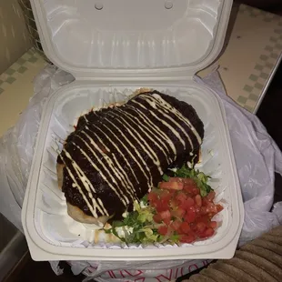 Chicken Burrito topped with Mole