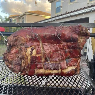 the meat being cooked on the grill