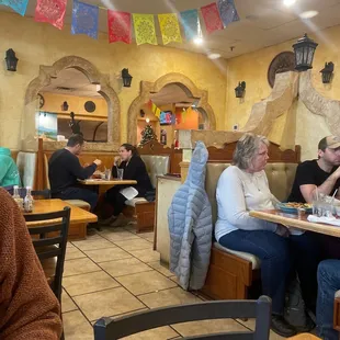 people sitting at tables in a mexican restaurant