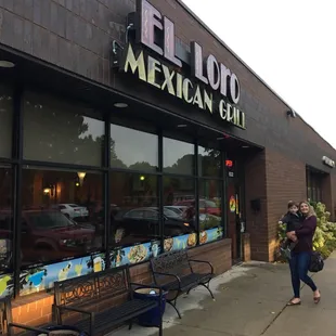a woman walking down the sidewalk