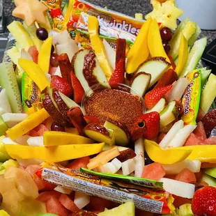 a platter of fruit and candy