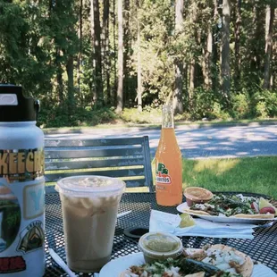 a plate of tacos and a drink