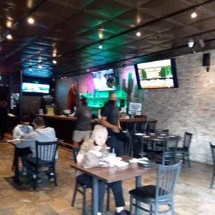 people sitting at tables in a restaurant