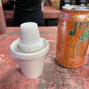 a can and a cup on a table