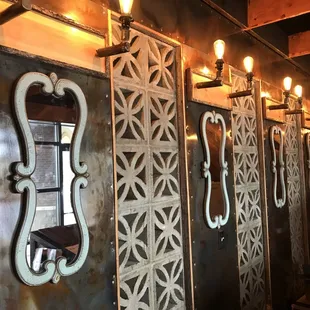 a row of mirrors on a wall