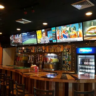 a bar with multiple televisions