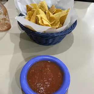 a bowl of chips and a bowl of salsa