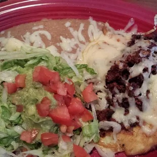 Pollo Michuacano.... Chorizo topped Chicken breast, refried beans salad with pico de Gallo &amp; guacamole