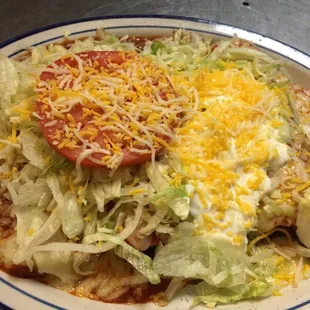 Enchiladas supreme consist in one cheese,beef,chicken and bean enchilada smothered with our special enchilada sauce