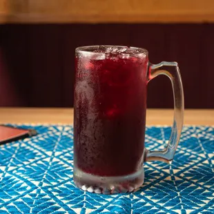 a glass of red drink
