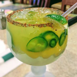 Spicy Margarita   Has fresh jalapenos and a red peppered rim   Not very hot but very delicious