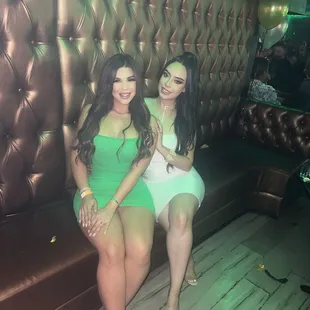 two women sitting on a couch