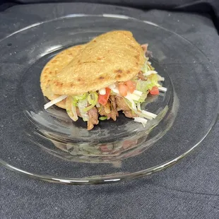 a sandwich on a glass plate