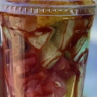 Fruit cup with watermelon, pineapple, cucumber, mango, cantaloupe, chamoy and chili (powder Lucas)