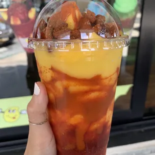 a hand holding a cup of iced tea