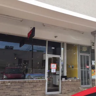 There is no sign for it but the address is on the door. It looks closed but the door is open.