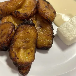 Sweet fried plantains with crema.  Queso blanco