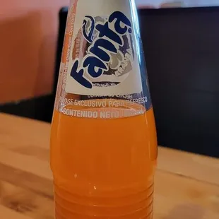 a bottle of orange soda
