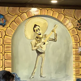 a woman sitting at a table in a mexican restaurant