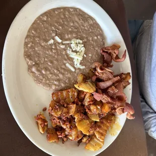 Papas con chorizo, bacon, and beans.