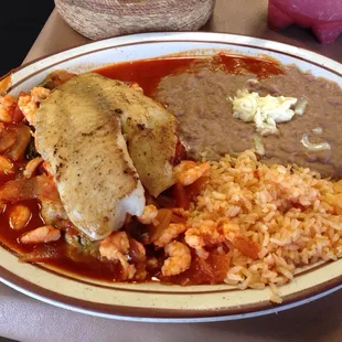 Chile Relleno seafood platter. Chile relleno under shrimp under a fish filet. With a side of beansrice and homemade tortillas