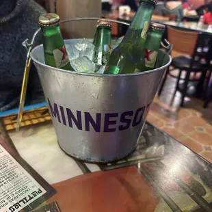 a bucket full of beer bottles