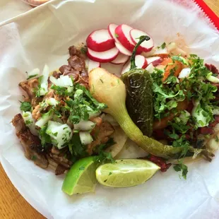 Tacos al pastor and carnitas. The al pastor is not off a spit but the carnitas is legit! And they have grilled cebollitas, too!