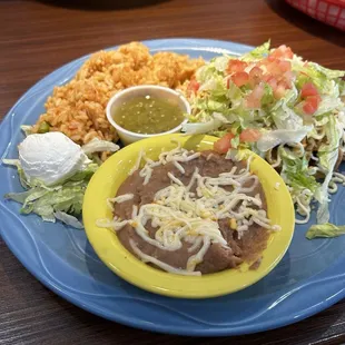 There carnita taquitos with rice and beans and green salsa.  Awesome.