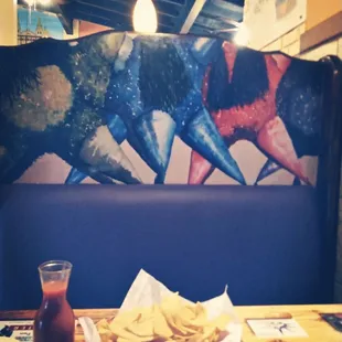 a table with a plate of nachos and a drink