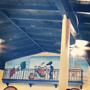 a mural on the ceiling of a restaurant