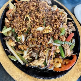 The parallida for two, fajitas, beef, chicken, pork, shrimp, chorizo, tomatoes, onions and rice and beans. Very good!!