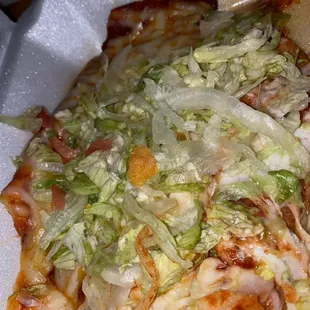 Beef enchiladas with cheese and lettuce