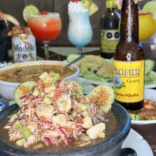a bowl of food and a bottle of beer