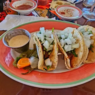 a plate of tacos and salsa