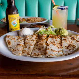 Stuffed quesadilla with sour cream and guacamole