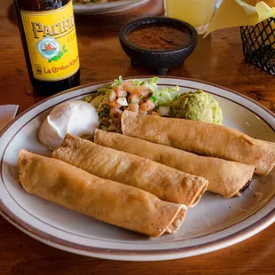 Taquitos with sour cream and guacamole