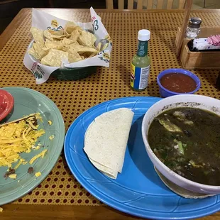 Taco and a bowl of black bean soup and it's full of yummy black beans and topped with fresh avocado slices!