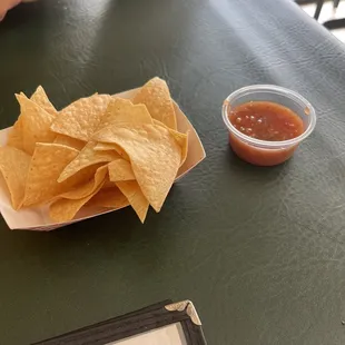 a plate of chips and a bowl of salsa