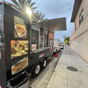 a food truck parked on the side of the road