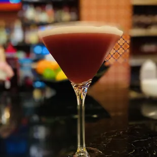 Martini de Granada - orange vodka, pomegranate licor, egg white, orange, and vanilla beans. It&apos;s an acquired taste, but not bad.