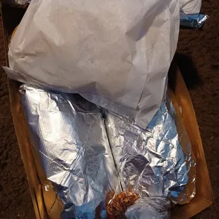 a box of wrapped sandwiches
