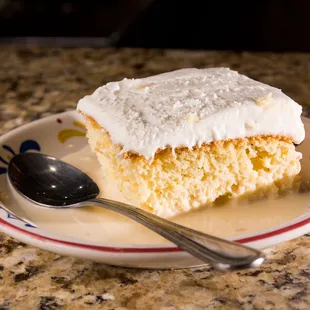 a piece of cake on a plate with a spoon