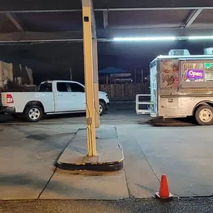 two food trucks in a parking garage