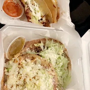 two hot dogs in a styrofoam container